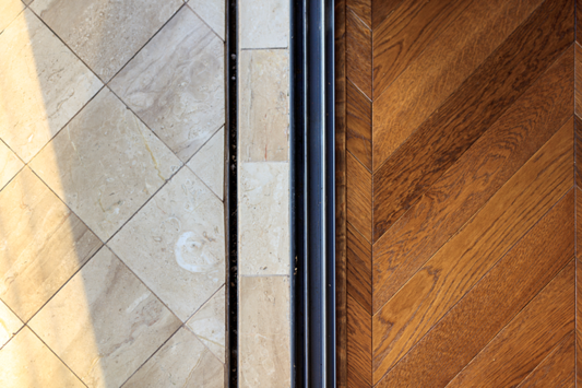 marble floor tiles and wooden parquet flooring