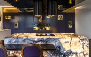 purple and gold kitchen area with marble kitchen island