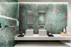 amazonite wall in bathroom with white basins and mirrors